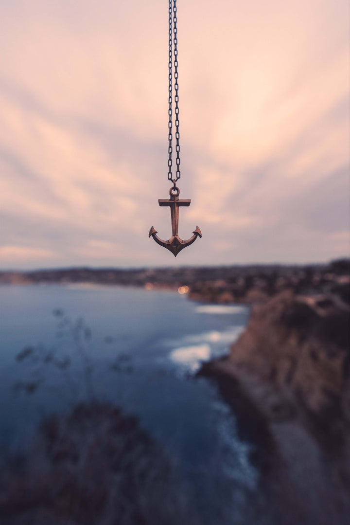 Handcrafted solid bronze anchor necklace on an antique bronze chain. Unisex. Custom lengths available. Made in USA with a lifetime warranty.